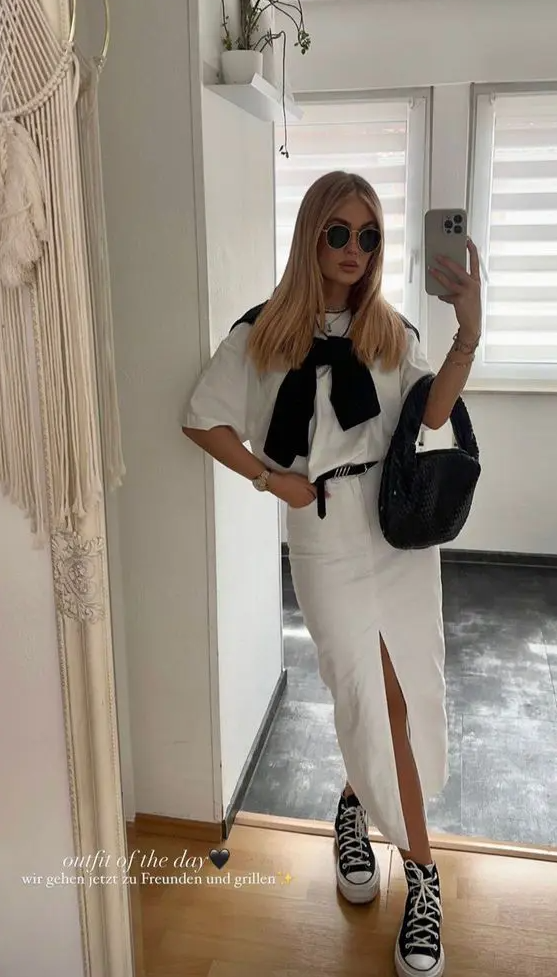 a comfortable spring look with a white t-shirt, a denim maxi skirt, a black jumper, bag and high top sneakers plus sunglasses