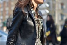 a trendy 90s inspired look with an animal print shirt, a black leather blazer and black jeans