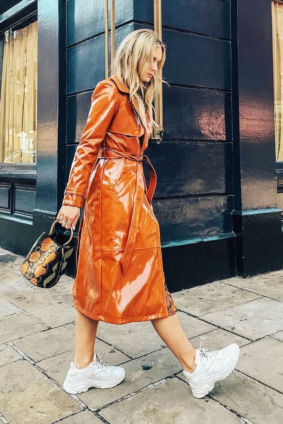 an orange patent leather trench, white trainers and a snakeskin bucket bag for an ultimate spring look