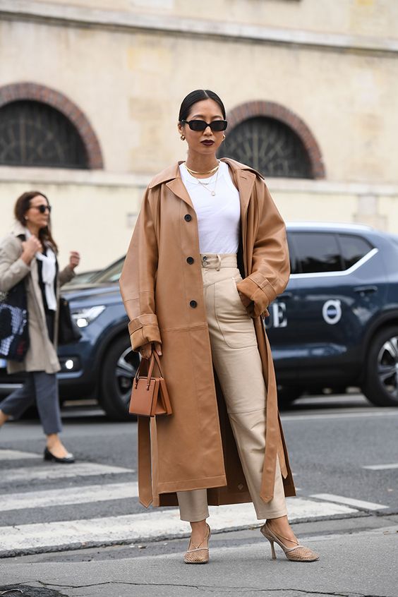 neutral high waisted pants, a white tee, neutral wire square toe shoes, a camel leather trench and a small bag