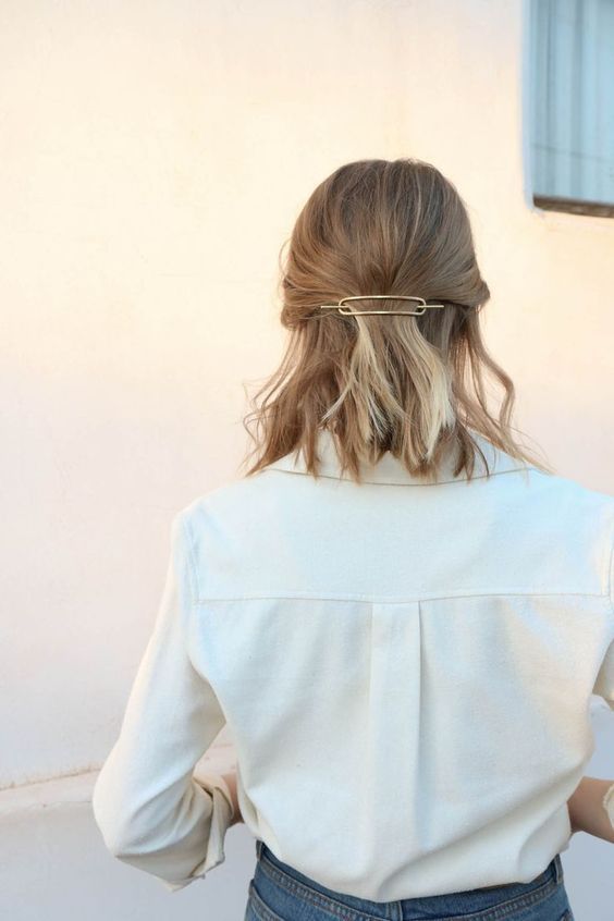 a casual half updo with a messy top and waves plus a berrette is a way to show off your favorite accessory