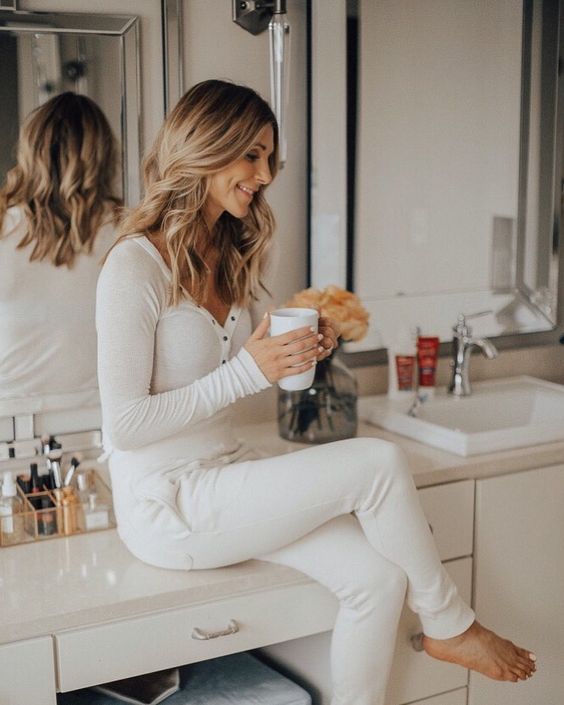 white pajamas with a long sleeve top on buttons and joggers look chic, bright and very stylish
