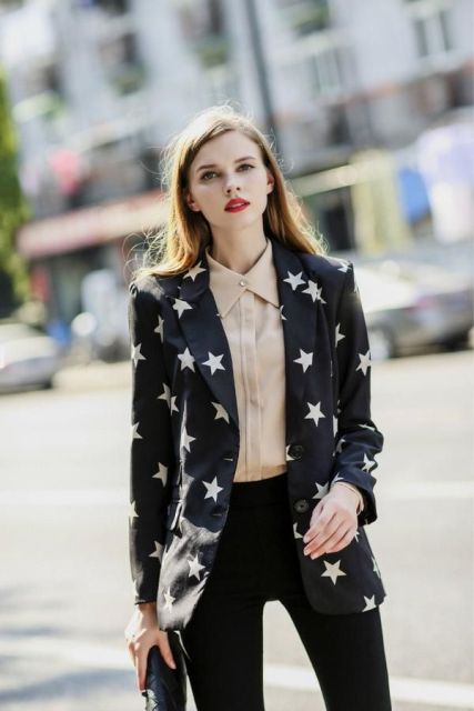 With beige button down shirt, black clutch and black trousers