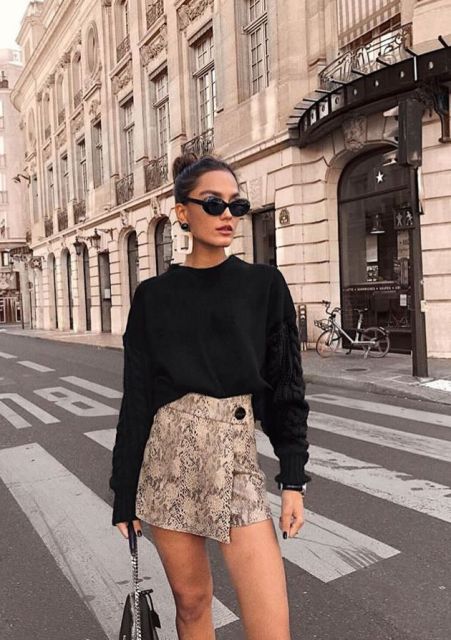 With black loose sweater, sunglasses and black bag