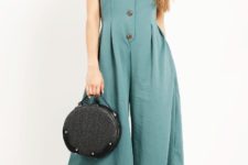 With black rounded bag and white high heels