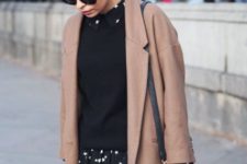 With black sweater, brown coat and black bag