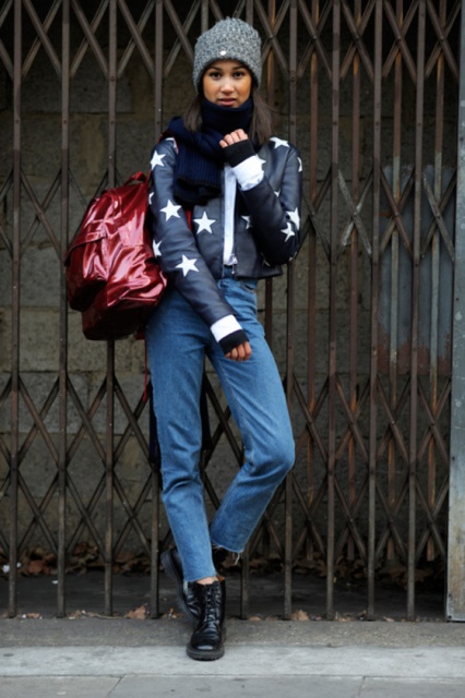 With cropped jeans, black flat boots, hat and backpack