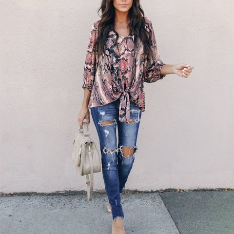 With distressed jeans, gray bag and shoes