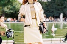 With golden shirt, beige skirt, two colored shoes and black clutch