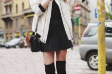 With mini pleated skirt, black shirt, bag and over the knee boots