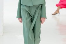 With mint green loose trousers, beige shoes and brown shirt