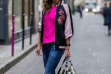 With pink shirt, distressed jeans, striped bag and silver sandals