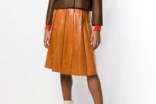 With red turtleneck, brown leather pleated skirt and beige ankle boots