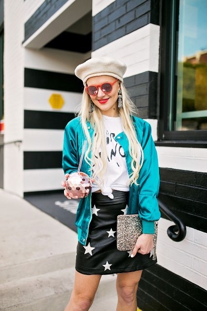 With t shirt, beige beret, embellished clutch and bomber jacket