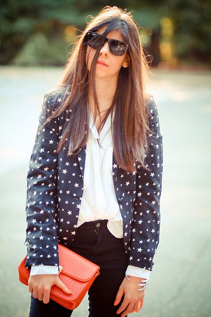 With white blouse, black pants and red clutch