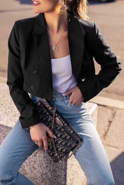 With white top, printed bag and light blue jeans