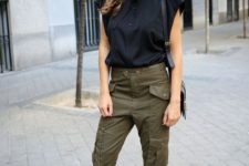 a black blouse, green cargo pants, burgundy shoes and a black bag for a trendy summer outfit