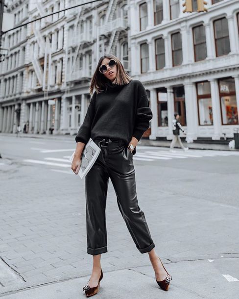 a black sweater, black cropped leather pants, brown velvet shoes with embellishments