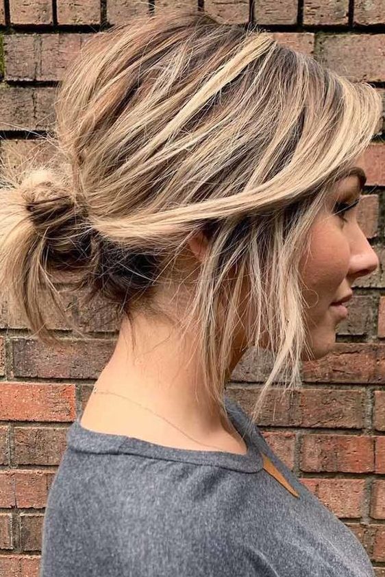 a casual updo on short hair, a low messy bun with a messy top and some hair down is a cool idea you can make on the go