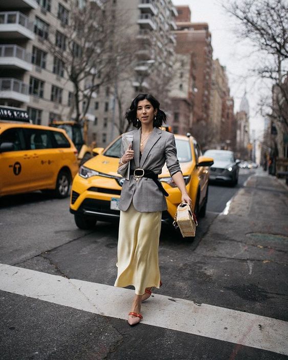 a catchy work look with a black top, an oversized blazer, a yellow slip skirt and bold shoes