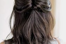a cool medium half updo with a looped ponytail, a bump on top and hair down is a cool solution