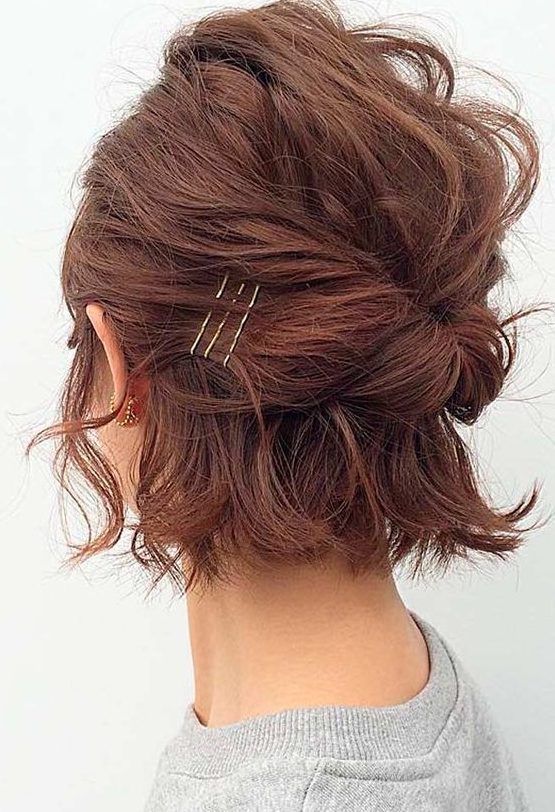 a emssy and textural burgundy midi bob styled with a bump on top and some twists plus bobby pins is cool