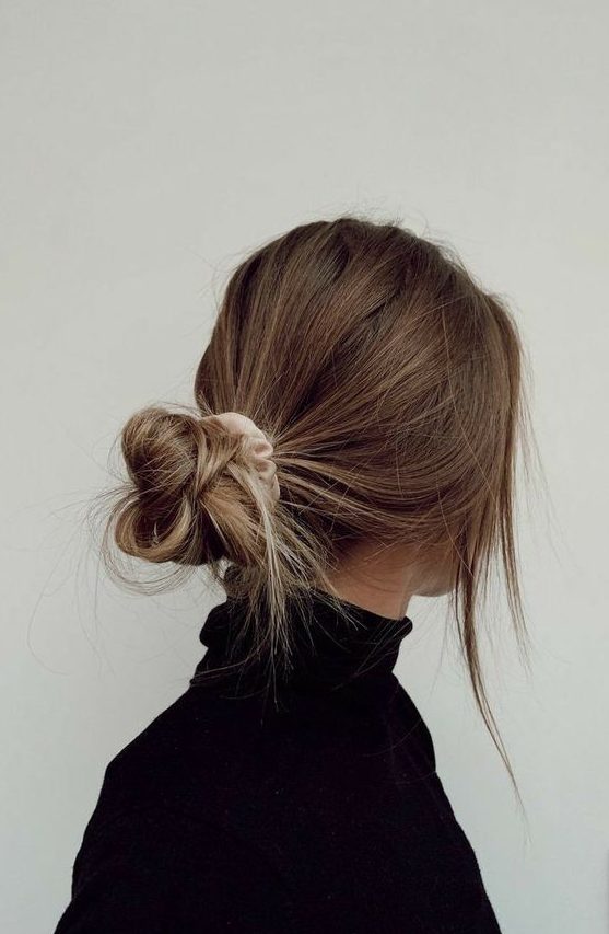 a fast messy low bun with a scrunchie and some locks down is a cool and easy to make solution