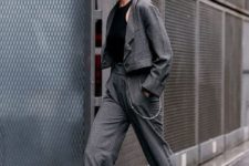 a grey pantsuit with a cropped blazer, cropped pants, a black halter top, silver shoes for work