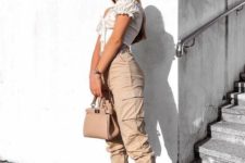 a hot outfit with tan cargo pants, a white off the shoulder top, white trainers and a tan bag