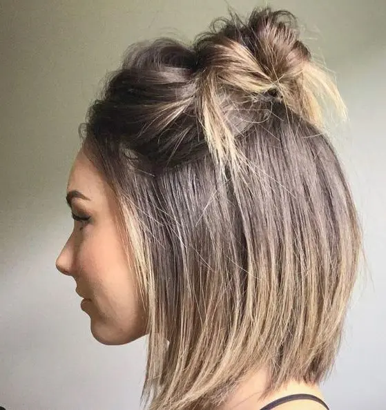 a long bob with a top knot and a messy bump on top is a cool and very relaxed idea for every day