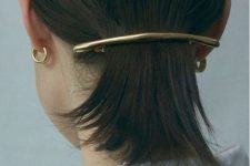 a low ponytail secured with a minimalist hair barrette is a cool modern hairstyle
