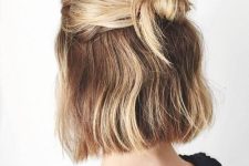 a messy half updo with knotted hair and a messy bump on top is a stylish hairstyle idea to try