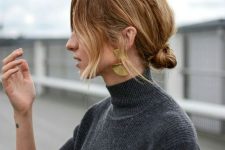a messy knotted low bun with some volume on top and face-framing hair is a cool and catchy decor idea