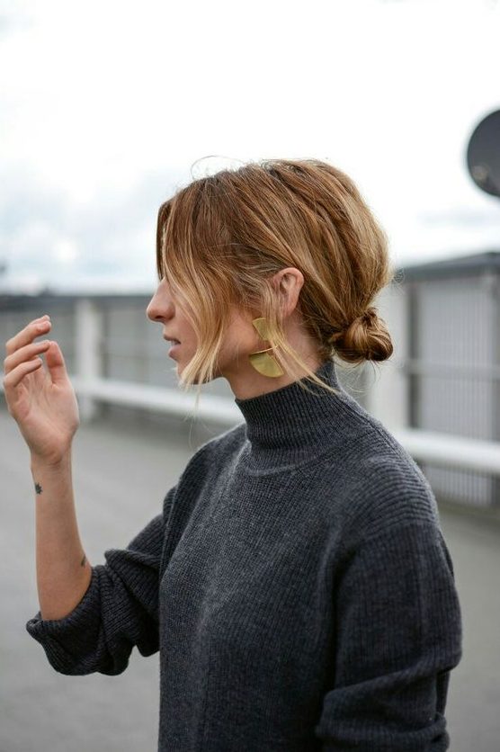 a messy knotted low bun with some volume on top and face-framing hair is a cool and catchy decor idea