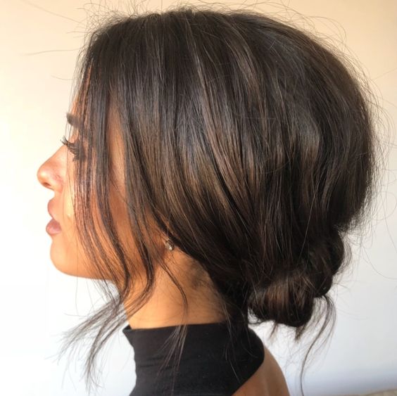 a messy low bun with a bump on top and face-framing hair is a cool and simple hairstyle idea that is suitable for any occasion