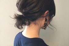 a messy low ponytail with a volumetric bump on top and some side bangs is a cool and lovely idea for short hair