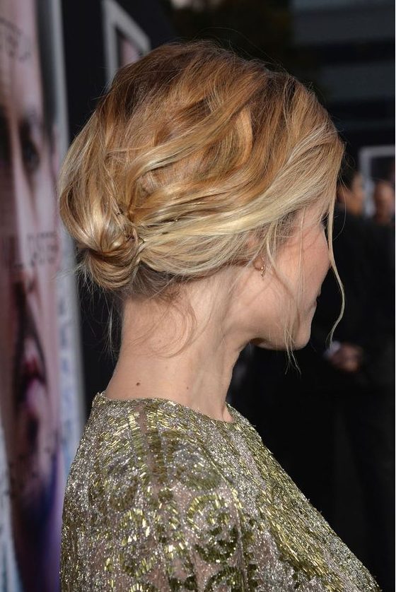 a messy short updo secured with bobby pins and with a wavy bump on top is a cool idea for a special occasion