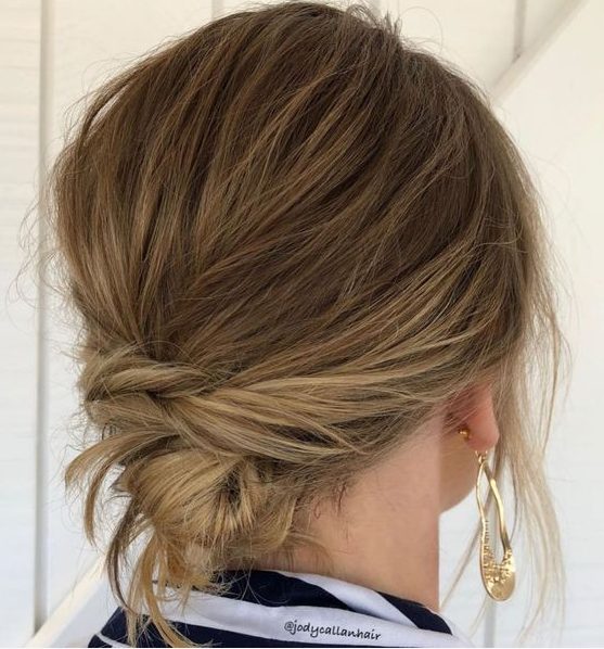 a messy twisted low updo with a messy bump on top and face-framing hair is a cool idea for many occasions