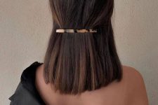 a minimal half updo with a sleek barrette and straight hair is a stylish and chic solution
