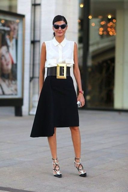 a refined monochromatic look with a sleeveless shirt, a black asymmetrical skirt, two tone shoes and a statement belt