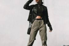 a sexy spring outfit with a black crop top, olive green cargo pants, a black leather jacket and black booties