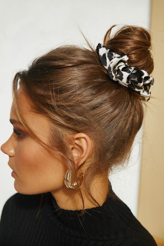 a simple top knot with a printed scrunchie and some messy hair is a cool idea you can rock anytime