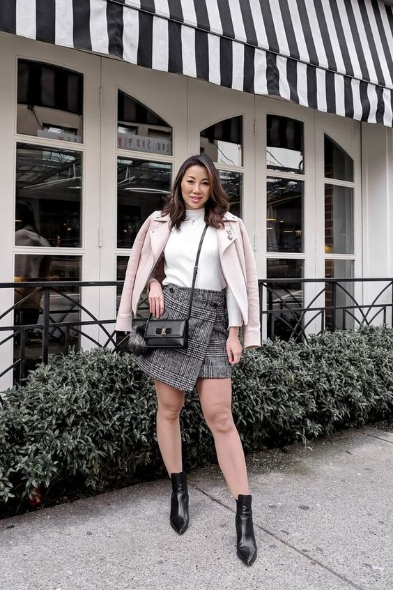 a spring work look with a white turtleneck, a grey plaid asymmetrical mini, black booties and a pink coat