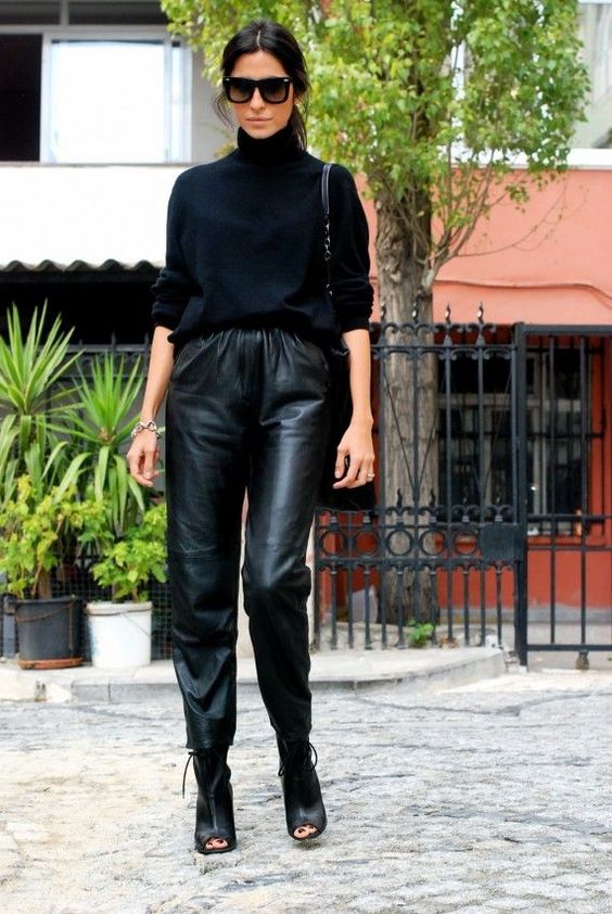 a stylish outfit with a black turtleneck, black leather pants, black peep toe booties and a black tote