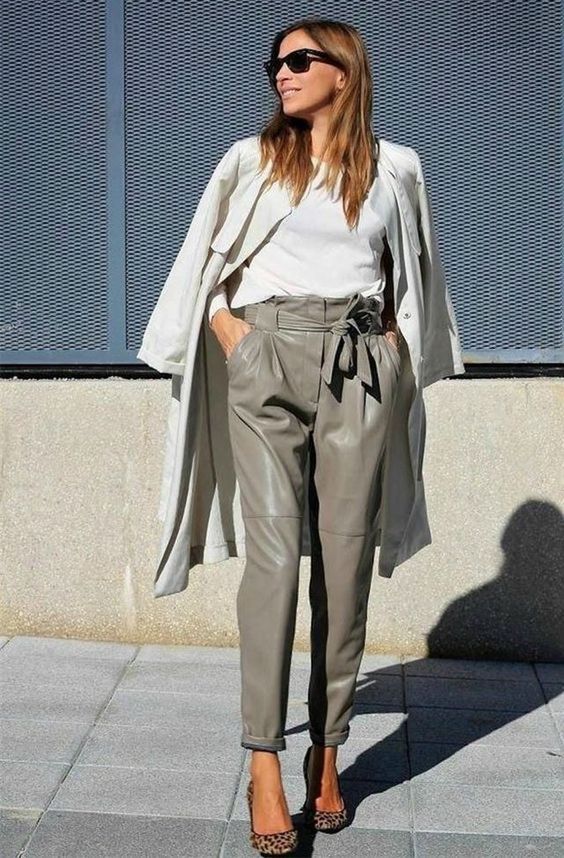 a stylish spring work look with a white tee, an off white trench, grey high waisted leather pants, animal print shoes