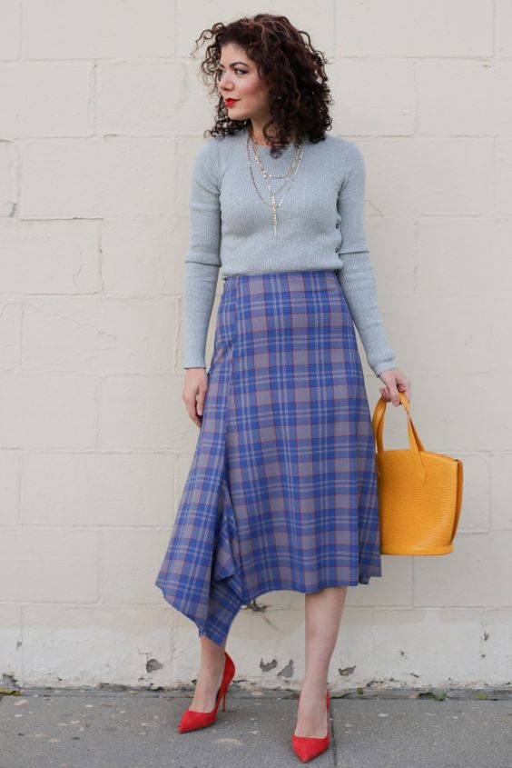a super bright work look with a grey top, a purple plaid asymmetrical midi, red shoes and a mustard bag