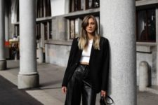 a white crop top, a black blazer, black leather bermudas, black boots and a small bag for a trendy look