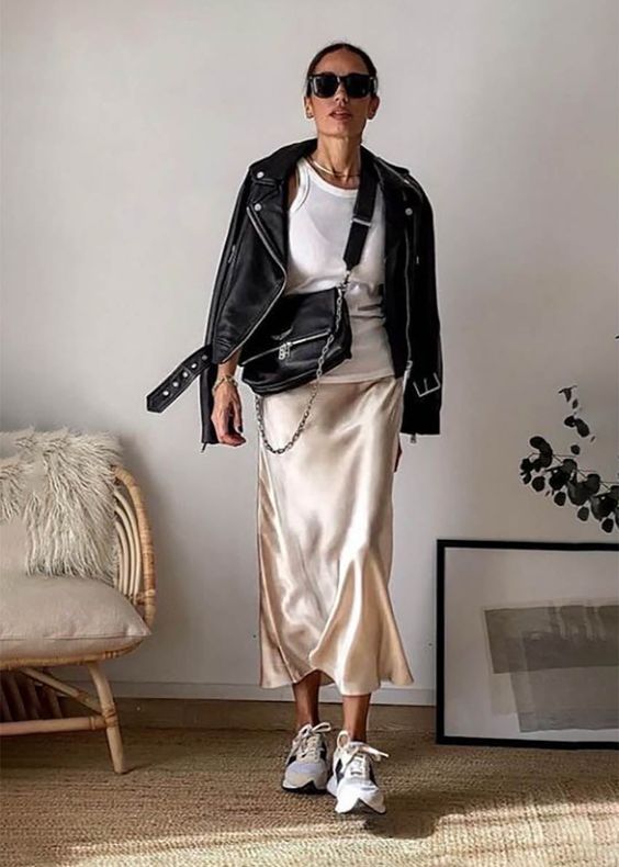 a white tank top, a neutral satin skirt, white trainers, a black leather jacket and a black bag are great for spring