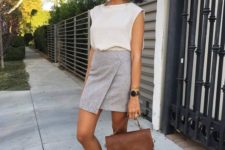 a white top, a grey asymmetrical mini skirt, lavender flats and a brown bag for a summer work look