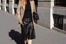 a work look with a black turtleneck, black leather bermudas, a tan oversized blazer, sheer black shoes and a black bag
